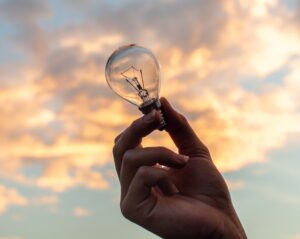 Lightbulb held up to the sky